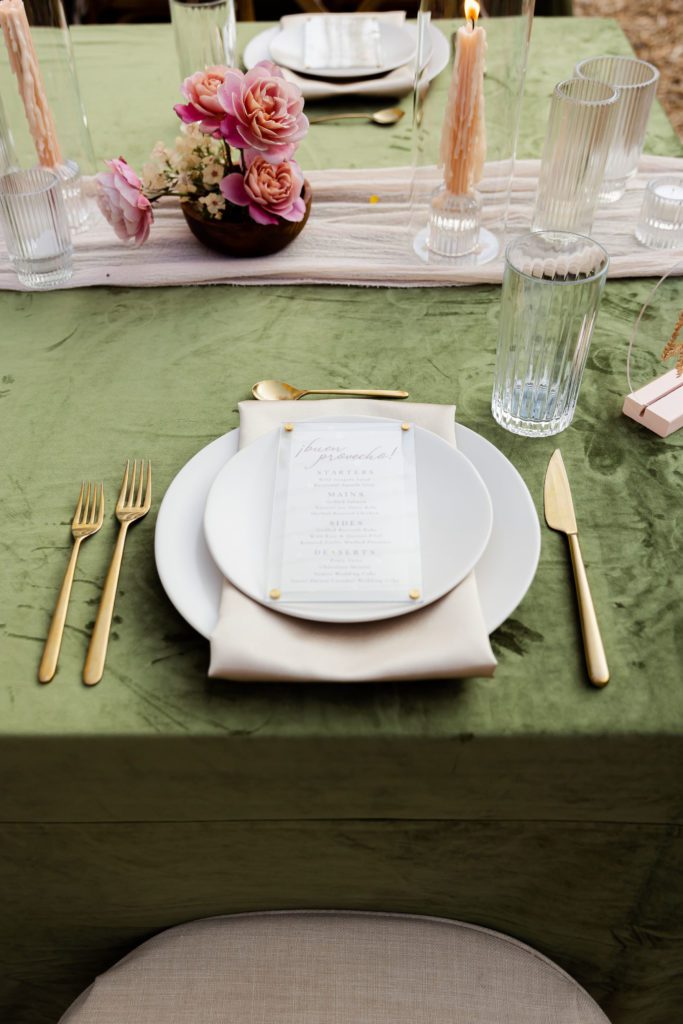 Park City wedding vendor catering menu is displayed on a floral filled tablescape.