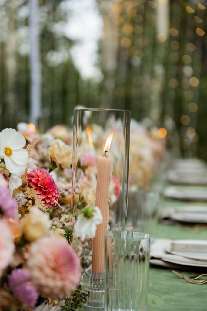 Summer floral wedding palette with a lit taper candle is captured by Park City wedding photographer and videographer.