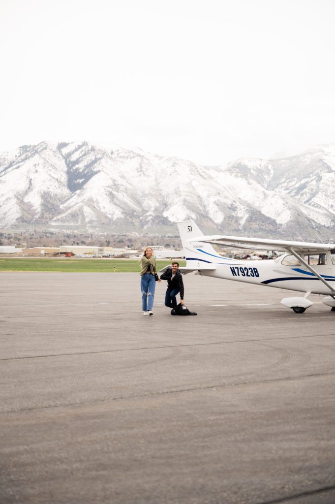 Maddie turns during surprise airport proposal in Logan, Utah.