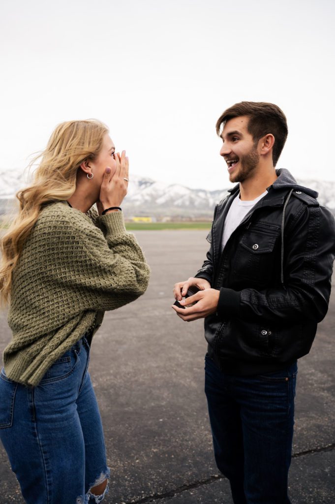 Utah bride reacts to being proposed to by pilot boyfriend at Logan airport.
