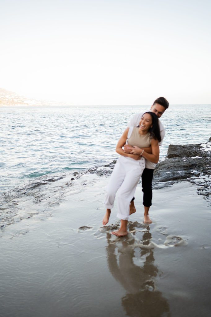 Laguna Beach wedding photographer and videographer are at an engagement photoshoot with casual couple.