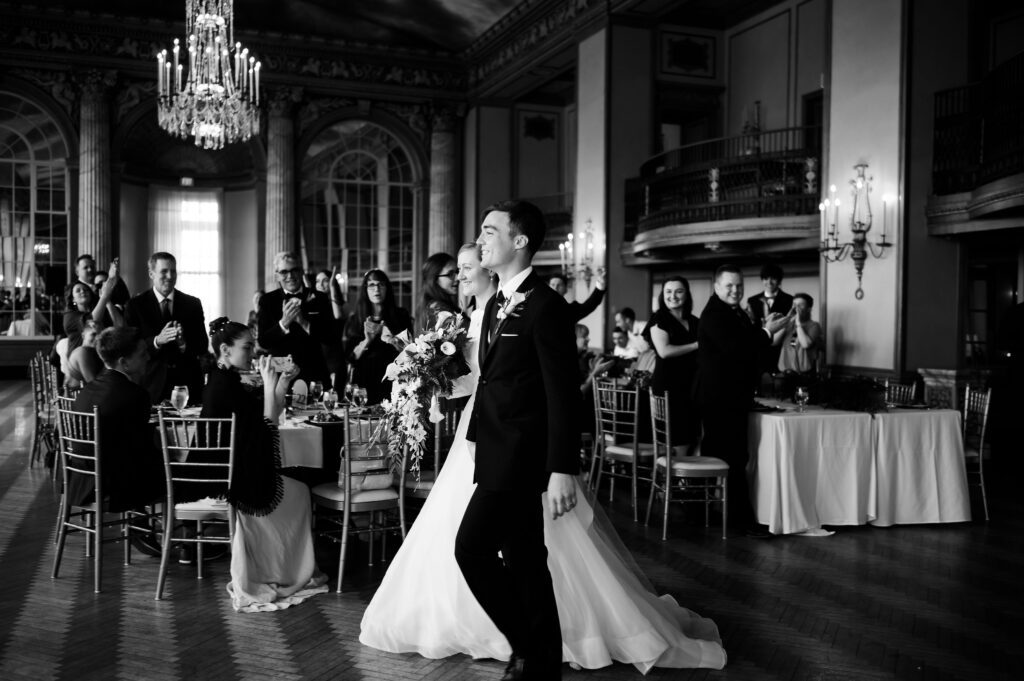 Bride and groom make their grand entrance onto the ballroom floor at their Marriott Syracuse downtown wedding.