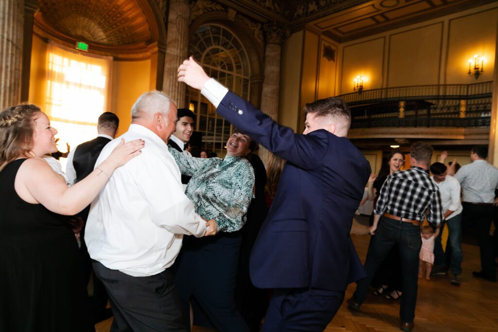 Wedding guests dance during wedding reception at Marriott Syracuse downtown.