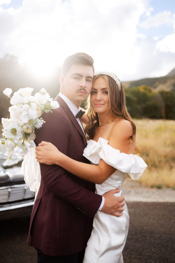 Classic vintage car bridals photoshoot by Dallas TX wedding photographer, white bouquet, groom's burgundy suit, fall wedding locations