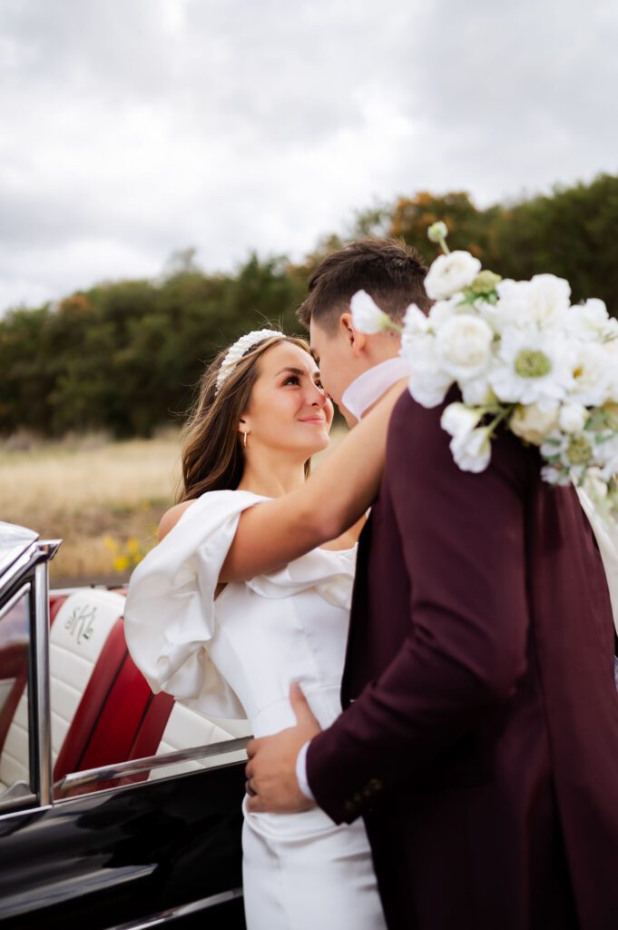 Classic Dallas TX wedding photographer, white bouquet, groom's burgundy suit