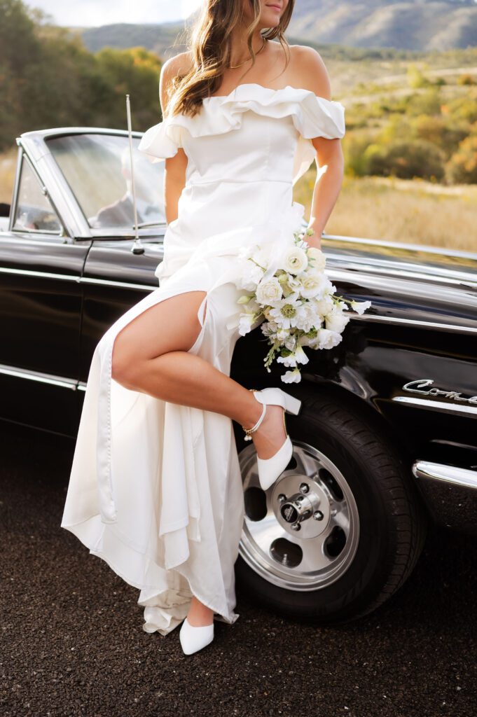 Classic vintage car bridals photoshoot by Dallas TX wedding photographer, white bouquet, groom's burgundy suit, classic florals, bride style