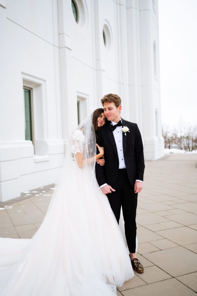 lovers at their classic fashion winter wedding at brigham city utah temple
