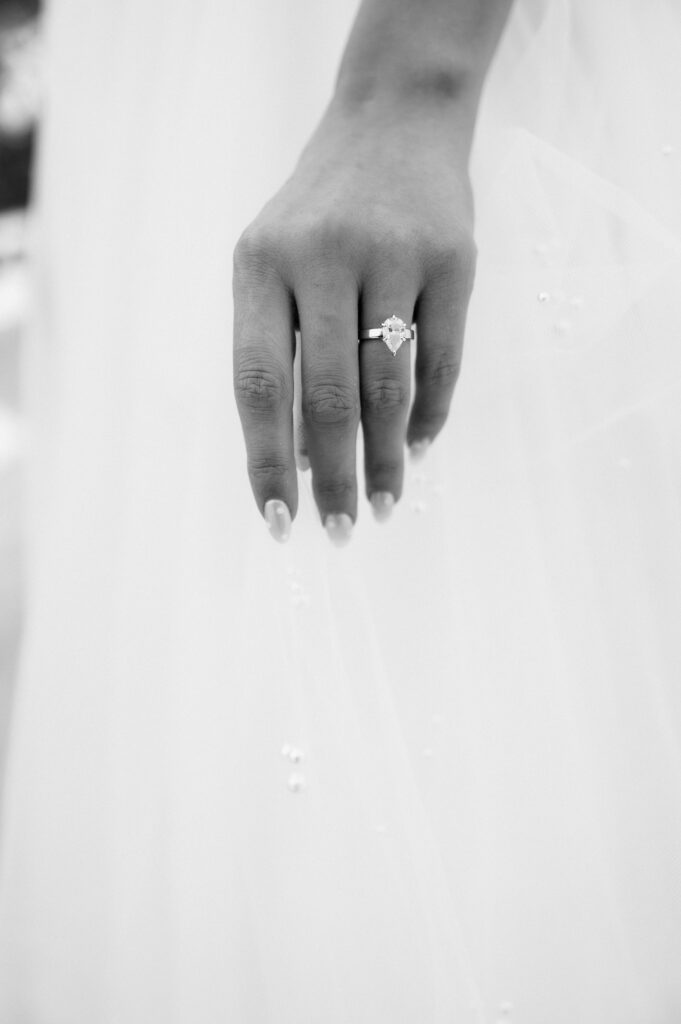 a detail of a Wilson Diamonds wedding ring on bride's hand