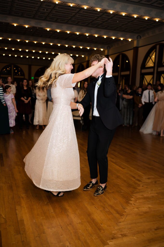 mother son dance with the groom at his classic fashion winter wedding