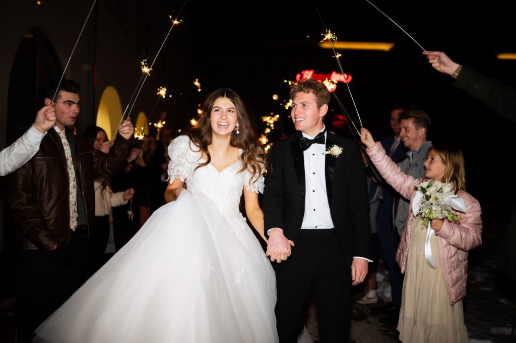 classic destination photographer captures sparkler exit at fashion winter wedding