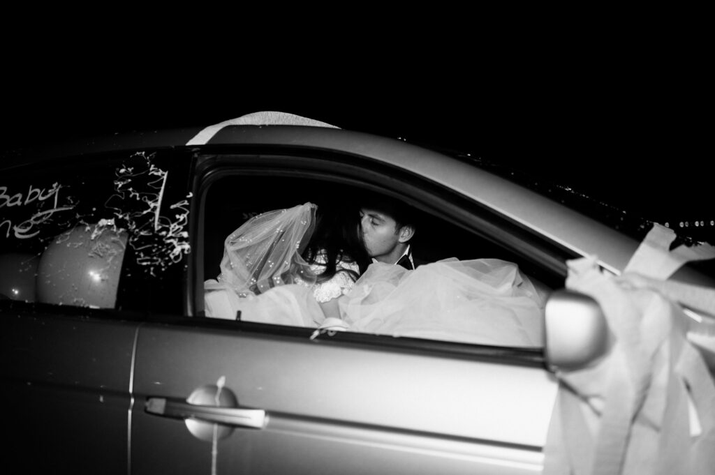 black and white photo of classic bridal fashion winter wedding exit