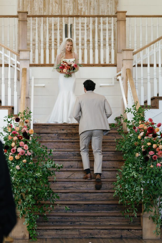 groom runs to meet bride walking down the wedding ceremony aisle