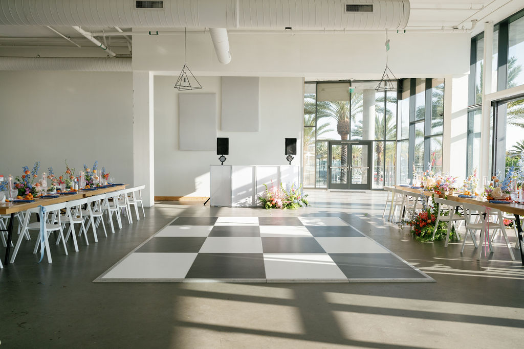 the lane wedding venue in san diego with colorful florals and checkered dance floor