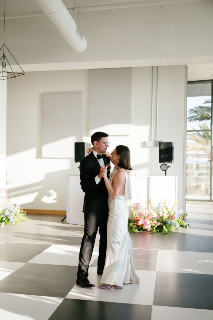 couple shares their first dance at the lane wedding venue in san diego california