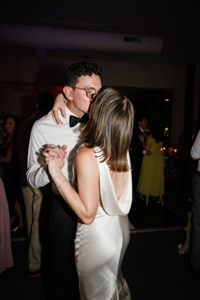 bride and groom kiss during wedding reception at the lane socal venue