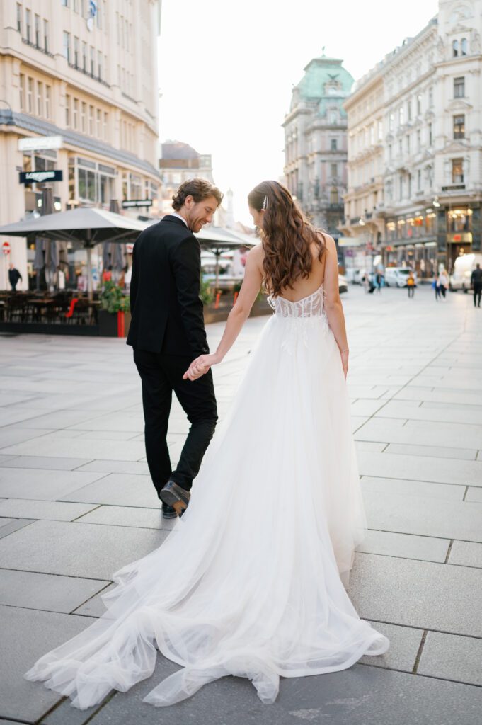A couple hand in hand walking during their wedding portraits captured by Vienna wedding Photographer