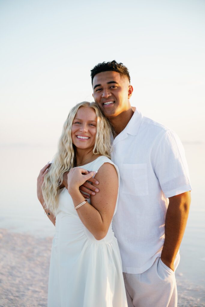 Couple portraits of people looking and smiling at the camera during Utah pink lake engagement photoshoot
