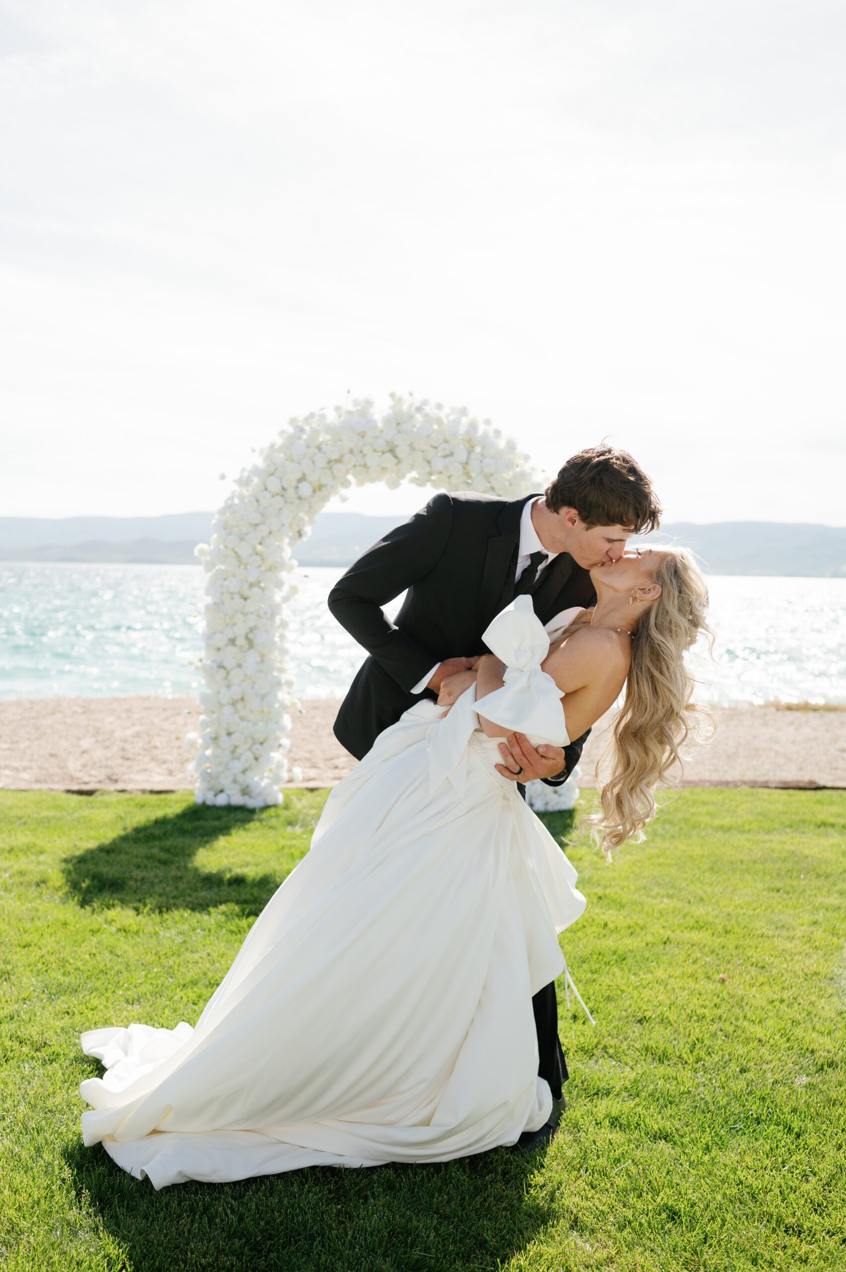 Couple kissing portrait with the beach in the background during Bear Lake Utah wedding
