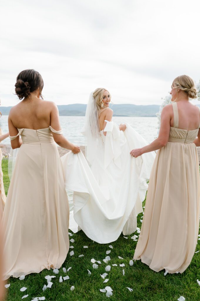 The bride and her bridesmaids with the beach in the background at Bear Lake Utah wedding