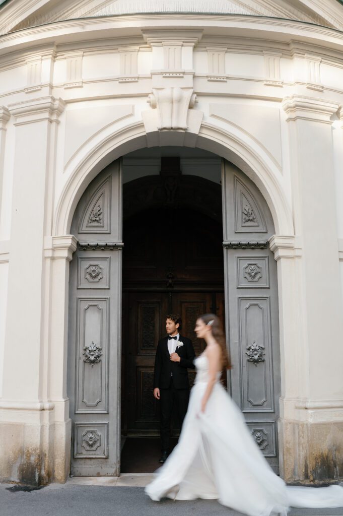 Bride and groom portrait in front of venue building captured by Vienna wedding Photographer