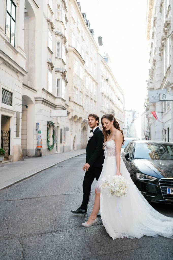 Bride and groom walking across the road during wedding portraits captured by Vienna wedding Photographer