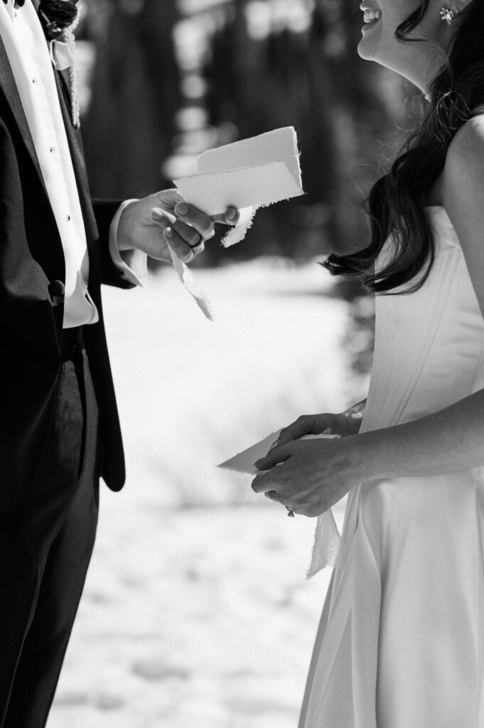 A close-up black and white shot of bride and groom saying vows during winter wedding at Snow Pine Lodge Park city
