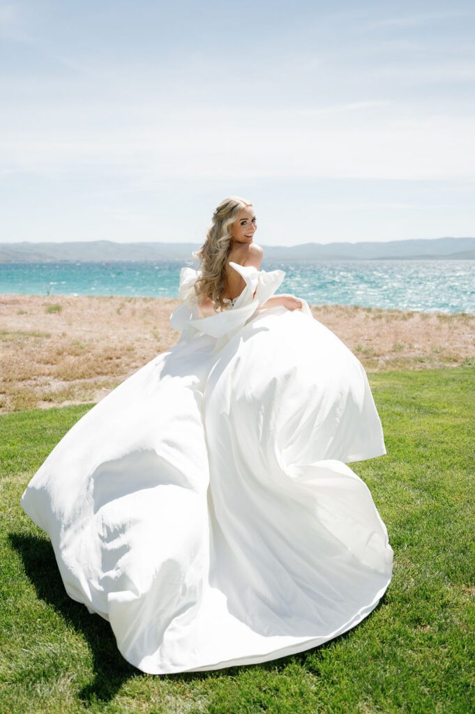 The bride in a flowy wedding dress with bow sleeves, bridal running pose